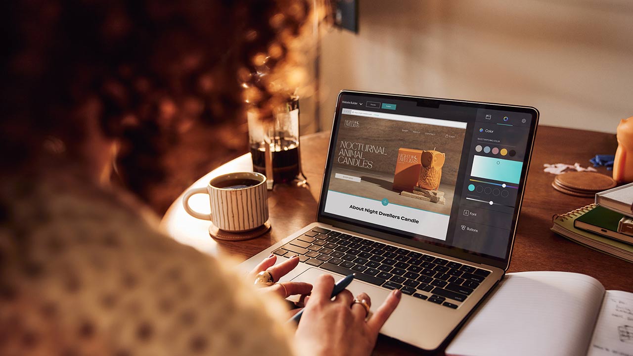 Woman building website on a laptop.