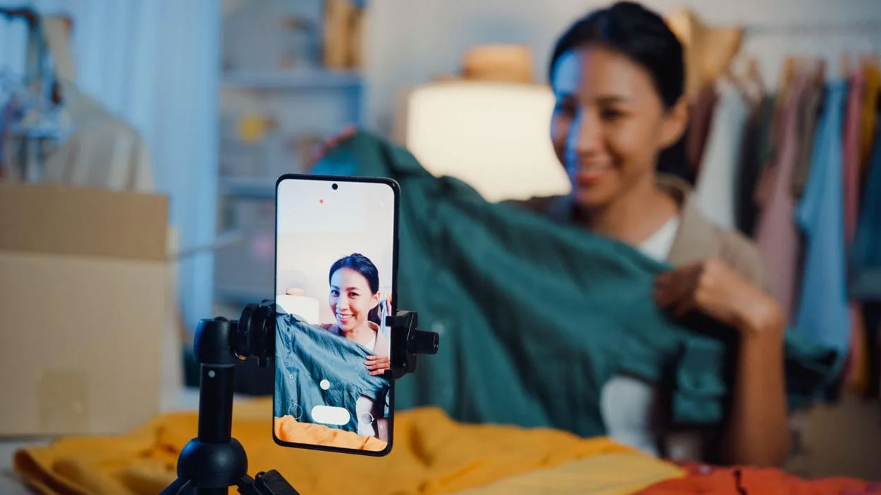 Woman recording video at her store.