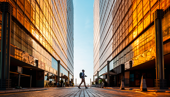 Tourist exploring hong kong among high rise buildings at sunset