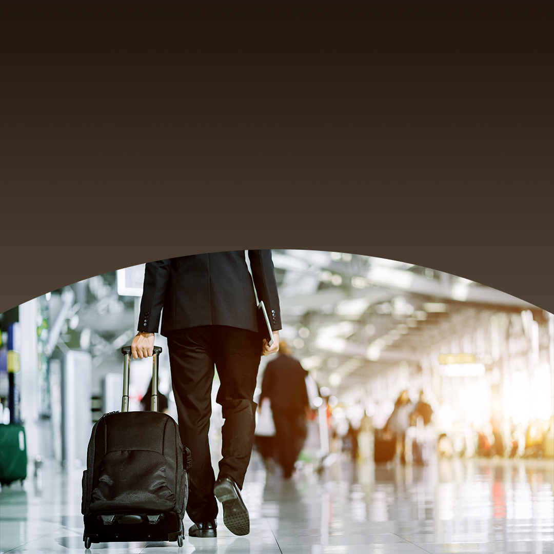 businessman walking with suitcase inside airport