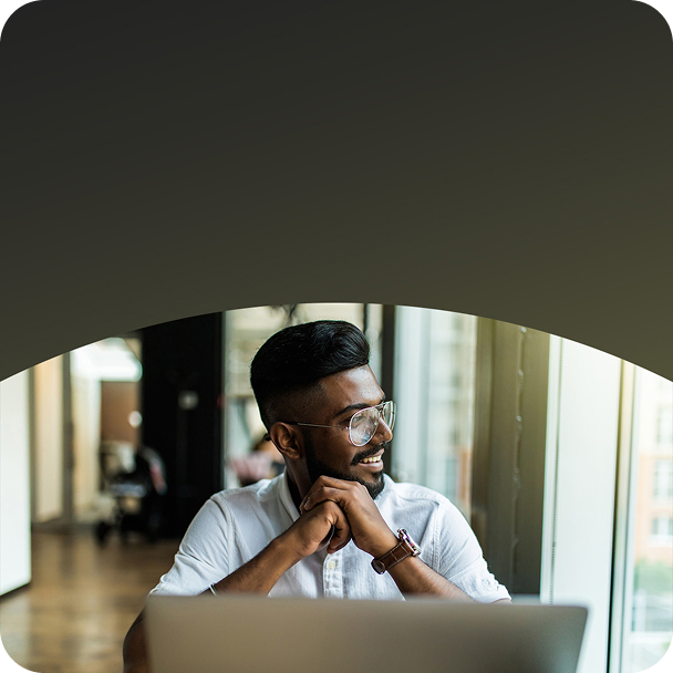 Man engaged in work on a laptop at his desk.