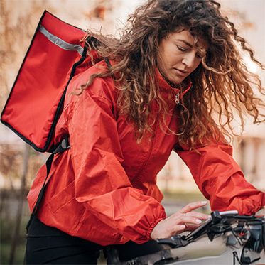 Women on cycle checking mobile.