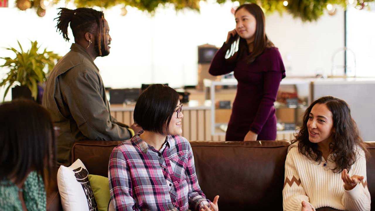 Four colleagues chatting together in an office.