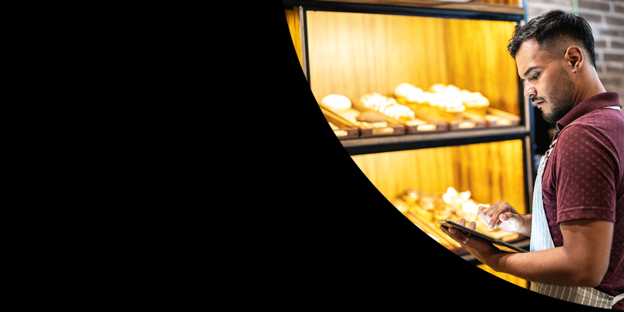 Man in front of food on tablet