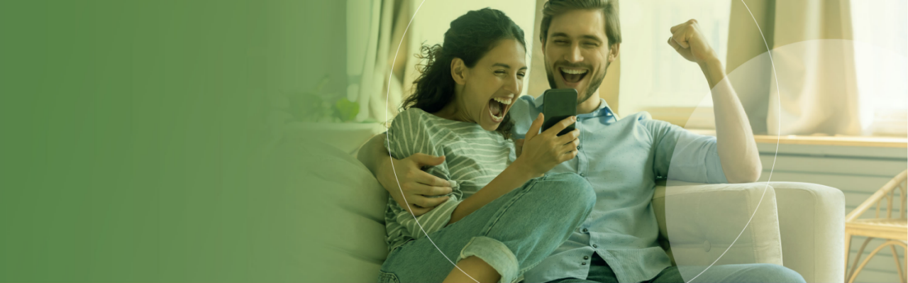 Couple on phone celebrating