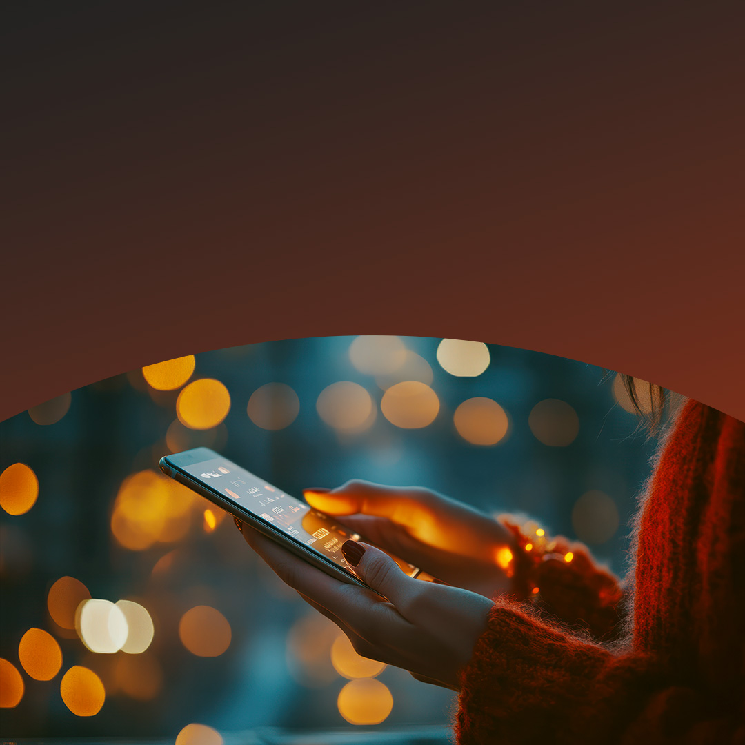Woman holding phone at concert. 