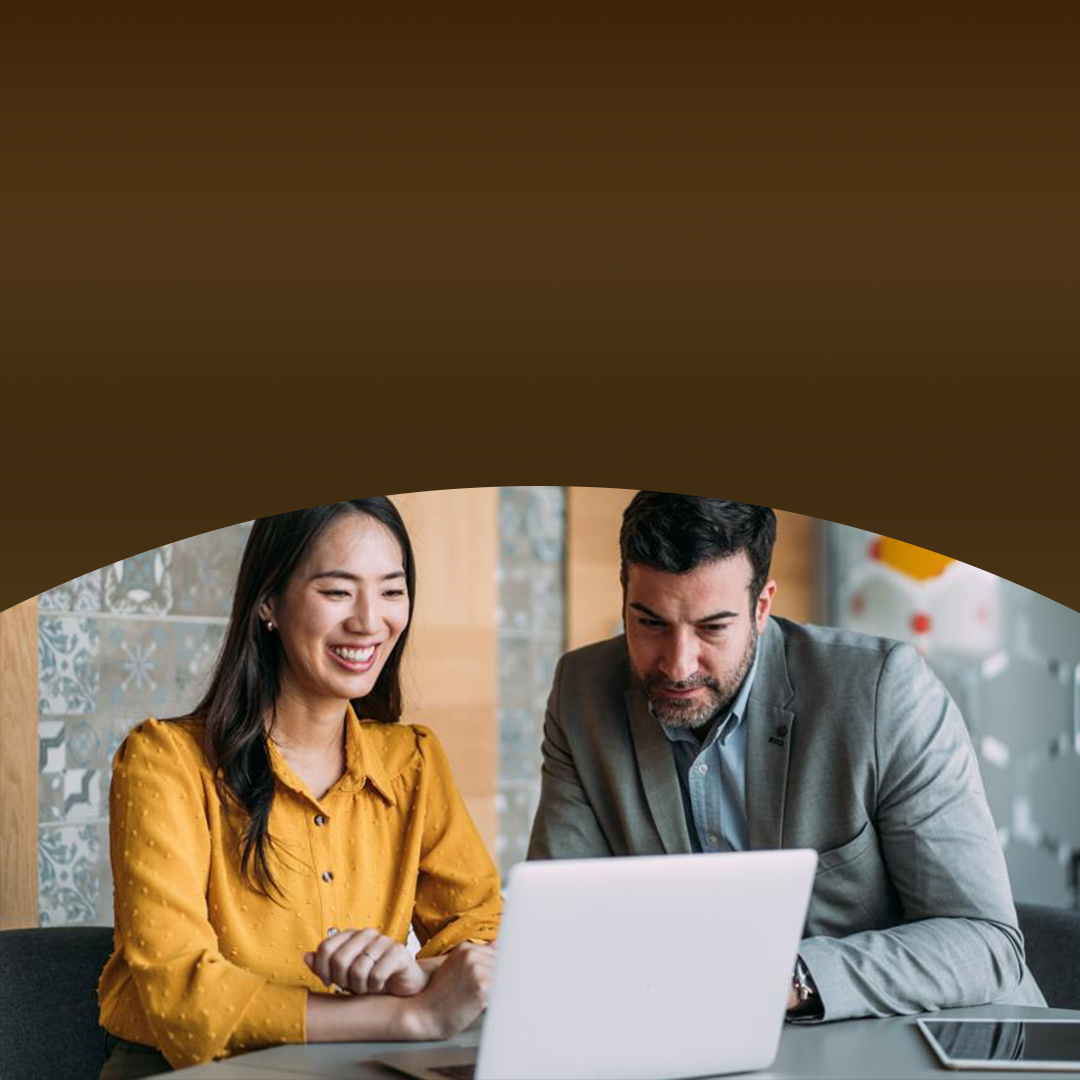 Man and woman working together at a laptop.