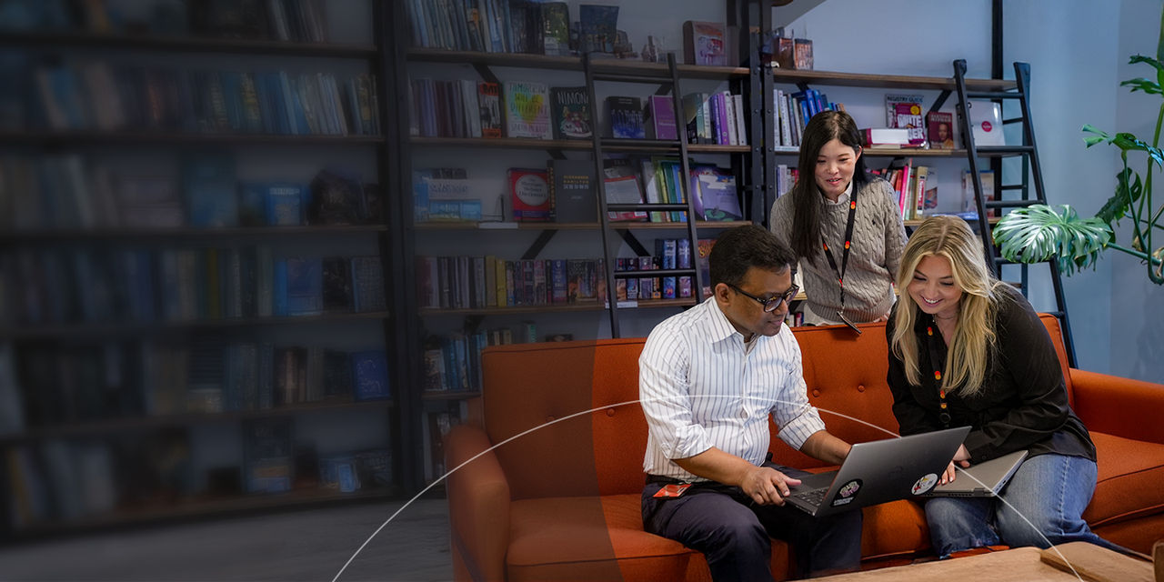 Two people sitting on a sofa using a tablet together.