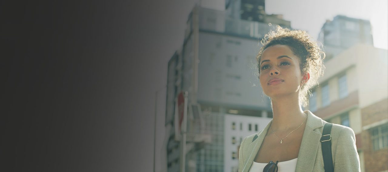 Woman standing in front of  buildings.